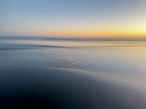 Images Dated 31st October 2024: Abstract blur of sunset over water-covered beach
