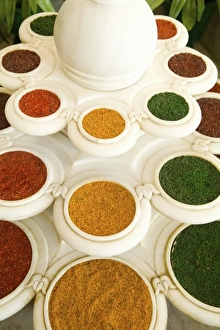 Flavor Prints: Abstract colorful bowls of spices in vases from above in Agra India