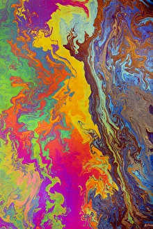 Abstract pattern in oil spilled in small stream, Costa Rica