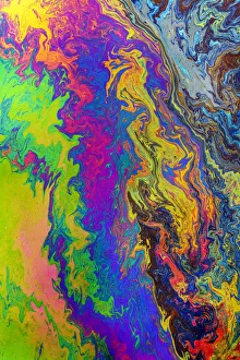 Abstract pattern in oil spilled in small stream, Costa Rica