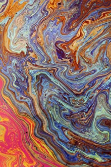 Abstract pattern in oil spilled in small stream, Costa Rica