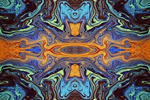 Abstract rainbow pattern of colors in oil spilled in small stream, Costa Rica