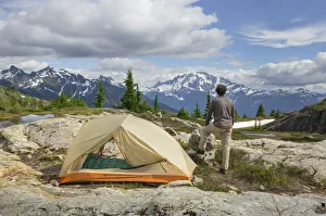 Hiking Prints: Adult man admiring view from backcountry campsite