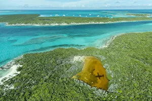 Exuma Collection: Aerial photo looking down at the airplanes shadow and clear tropical water