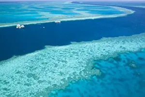 Sweeping Prints: Aerial view of The Great Barrier Reef by the Whitsunday Coast with diving boats anchored