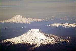 Aerial view of snow capped Mt. Adams and Mt. Rainier in the Washington Cascades