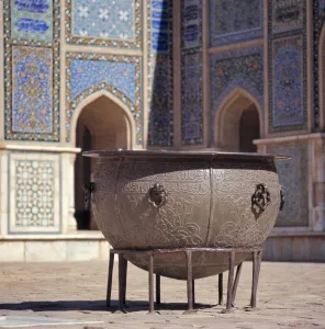 Afghanistan Prints: Afghanistan, Herat. An ancient brass cauldron rests in the inner courtyard