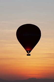 Images Dated 8th April 2024: Africa, Egypt, Luxor. Hot air balloon's travel over the Valley of the Kings at sunrise