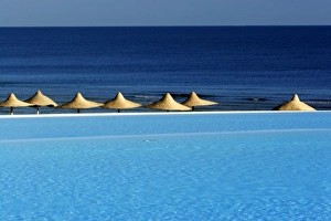 Africa, Egypt, Marsa Alam, Red Sea, beachside pool and umbrellas