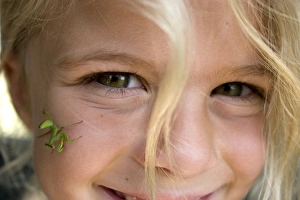 Images Dated 4th July 2007: Africa, Kenya. Praying Mantis on young girls face. (MR)