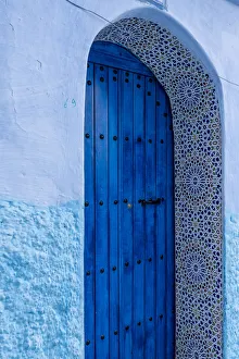 Africa, Morocco, Chefchaouen. Arch over wooden door