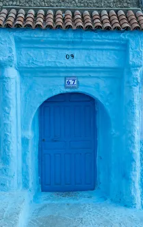 Africa, Morocco, Chefchaouen. Arch over wooden door
