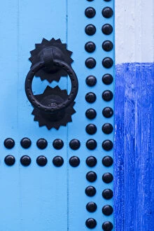 Africa, Morocco, Chefchaouen. Detail of blue door and doorknocker