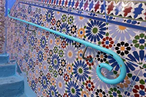 Africa, Morocco, Chefchaouen. Blue railing on decorated tile wall. ©Bill Young / Jaynes Gallery / DanitaDelimont.com