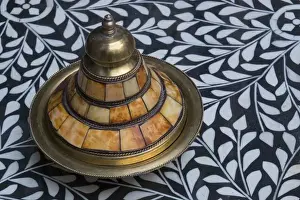 Décor Prints: Africa, Morocco, Fes. A covered brass bowl with inlay of camel bone sites on a stone