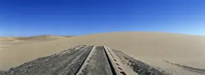 Africa, Namibia, Abandoned railroad tracks lead into sand dune in Forbidden Diamond