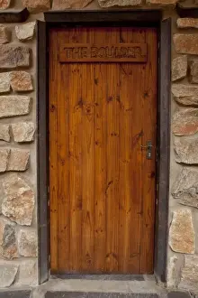 Chalet Prints: Africa, Namibia, Aus. Front door of Boulder chalet at the Klein Aus Vista. Credit as