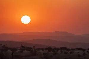Images Dated 30th August 2014: Africa, Namibia, Damaraland. Orange sunset over mountains