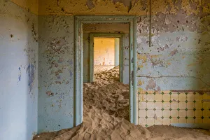Africa, Namibia, Kolmanskop. Doorways and drifting sand in an abandoned diamond mining town