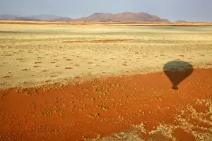 Africa, Namibia, Sossusvlei. Hot air ballooning over the red dunes, grasses
