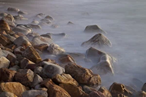 South Africa Collection: Africa, South Africa, Cape Town. Rocks and waves on Llandudno Beach at sunset. South Africa