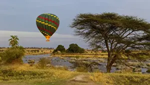 Tanzania Prints: Africa. Tanzania. Hot air balloon crossing the Mara river in Serengeti NP