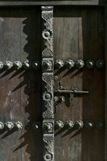 Images Dated 25th November 2005: Africa, Tanzania, Zanzibar, Stone Town, Morning sun lights elaborately carved wooden