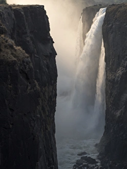 Images Dated 11th October 2017: Africa, Zimbabwe, Victoria Falls. Close-up of waterfall and spray at sunrise. Credit as