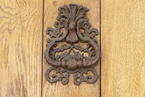 Aigues-Mortes, Gard, Occitania, France. An old rusted knocker on a wooden door