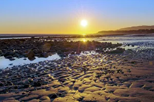 Alaska, Homer Spit. A sunset landscape over tide pools