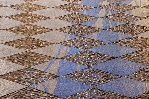 Prints of Albaicin, Province of Granada, Andalusia, Spain. Cut stone tiles and cobbles pave a plaza Images Dated 2024 December: Albaicin, Province of Granada, Andalusia, Spain. Cut stone tiles and cobbles pave a plaza