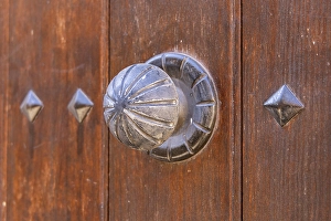 Prints of Albaicin, Province of Granada, Andalusia, Spain. Metal knob on an old wooden door Images Dated 2024 December: Albaicin, Province of Granada, Andalusia, Spain. Metal knob on an old wooden door