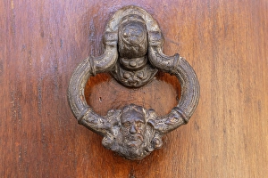 Prints of Albaicin, Province of Granada, Andalusia, Spain. An old metal knocker decorated with a human head, on a wooden door Images Dated 2024 December: Albaicin, Province of Granada, Andalusia
