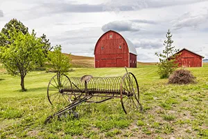 Albion, Washington State, USA. Red barns and antique farm equipment in the Palouse hills