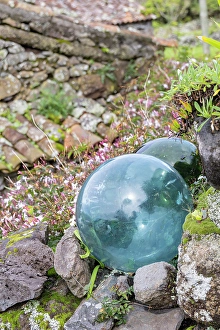 Buoy Prints: Aldeia da Cuada, Azores, Portugal. Glass fishing net floats in a garden on Flores Island