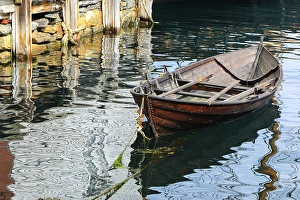 Jolly Sienda Prints: Alesund, Norway. Brown wooden canoe, water reflection