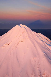 Alpenglow on Summit of Mt Taranaki / Mt Egmont at Dawn, and Shadow, Taranaki, North Island