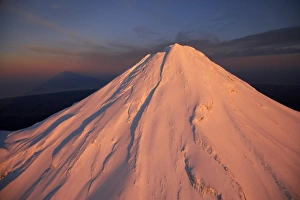 Alpenglow on Summit of Mt Taranaki / Mt Egmont at Dawn, and Shadow, Taranaki, North Island
