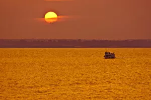 Amazon River, Brazil. Local passenger ferry at sunset