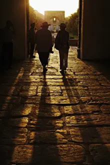 New Delhi Prints: American tourists silhouetted in entrance to Humayuns Tomb / Nizamuddin, India