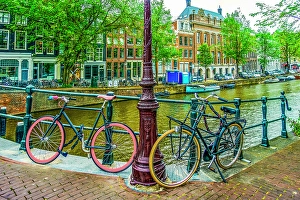 Bicycle Prints: Amsterdam, Netherlands. Wide angle landscape view of boat lined canal