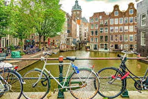 Bicycle Prints: Amsterdam, Netherlands. Wide angle landscape view of two canals merging to form a corner for historical buildings