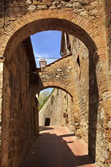 Italy Gallery: Ancient Stone Arches Street Flowers Medieval Town San Gimignano Tuscany Italy