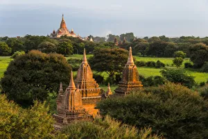 Images Dated 21st March 2015: Ancient temple and pagoda rising out of the jungle at sunrise, Bagan, Mandalay Region