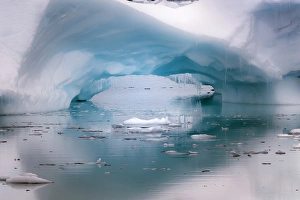 Opening Prints: Antarctica. Artistic open arch in an iceberg