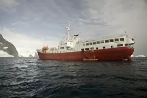 Antarctica. Expedition ship and zodiac off Pleneau Island