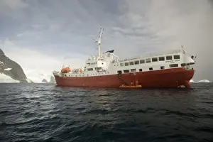 Antarctica. Expedition ship and zodiac off Pleneau Island