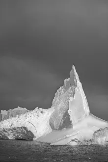 Images Dated 13th August 2020: Antarctica, South Georgia Island. Lone iceberg and stormy sunset