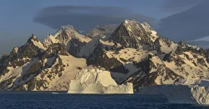 Images Dated 6th January 2020: Antarctica, South Georgia Island, Coopers Bay. Icebergs and mountains at sunrise
