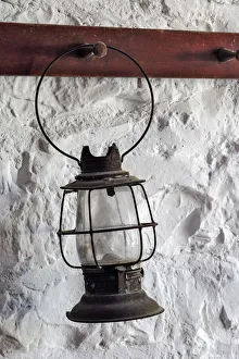 Hanging Prints: Antique lantern hanging on white wall